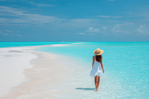 Woman walking on a tropical sandbar, a Nature Photo by AlyaAnd