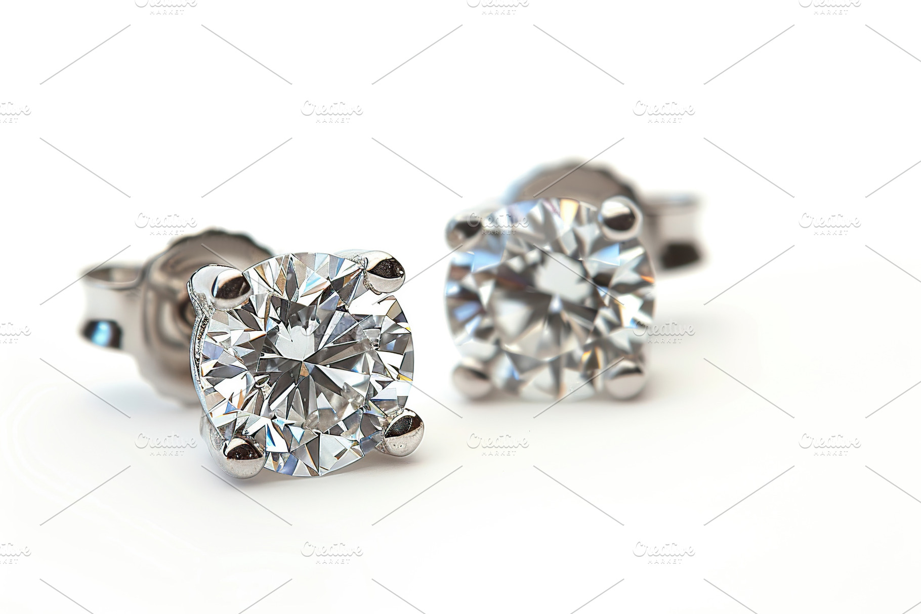Pair of big diamond earrings isolated on white background, a Beauty & Fashion Photo by AlyaAnd