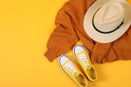 Sweater, sneakers and hat on yellow background, a Beauty & Fashion Photo by AtlasStudio