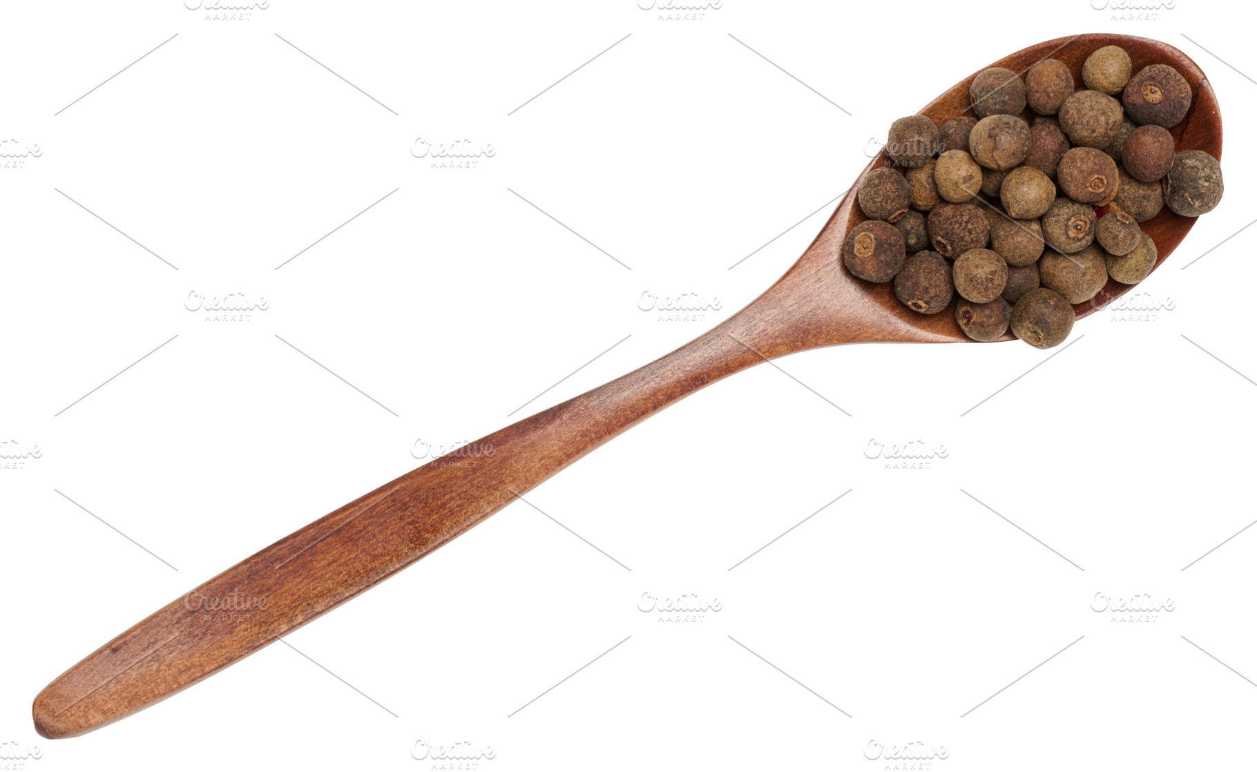 Allspice peas in a wooden brown spoon on an isolated background, a Food & Drink Photo by ndanko