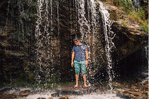 Man at waterfall in summer Altai, a Person Photo by Jan Jack Russo Media
