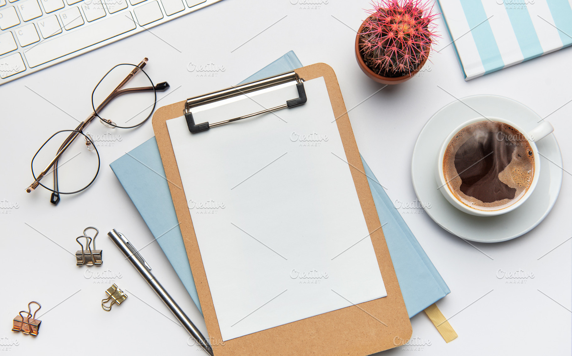 Clipboard with blank paper, coffee, cactus and office supplies o, a Business Photo by Olena Rudo