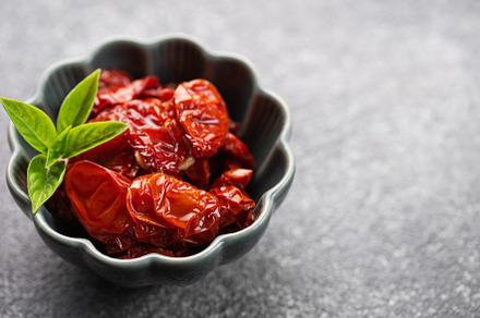 Bowl with sun dried tomatoes with fresh herbs and spices., a Food & Drink Photo by Olena Rudo