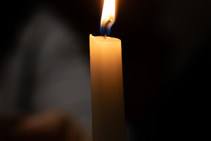 Close-up of a lit candle against a dark, blurred background, cre, a Holiday Photo by Ales Munt