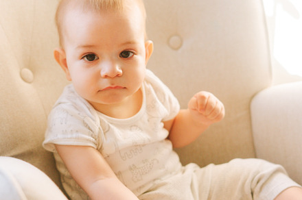Portrait of a nine month old baby sitting in a rocking chair, a Person Photo by rubenchase