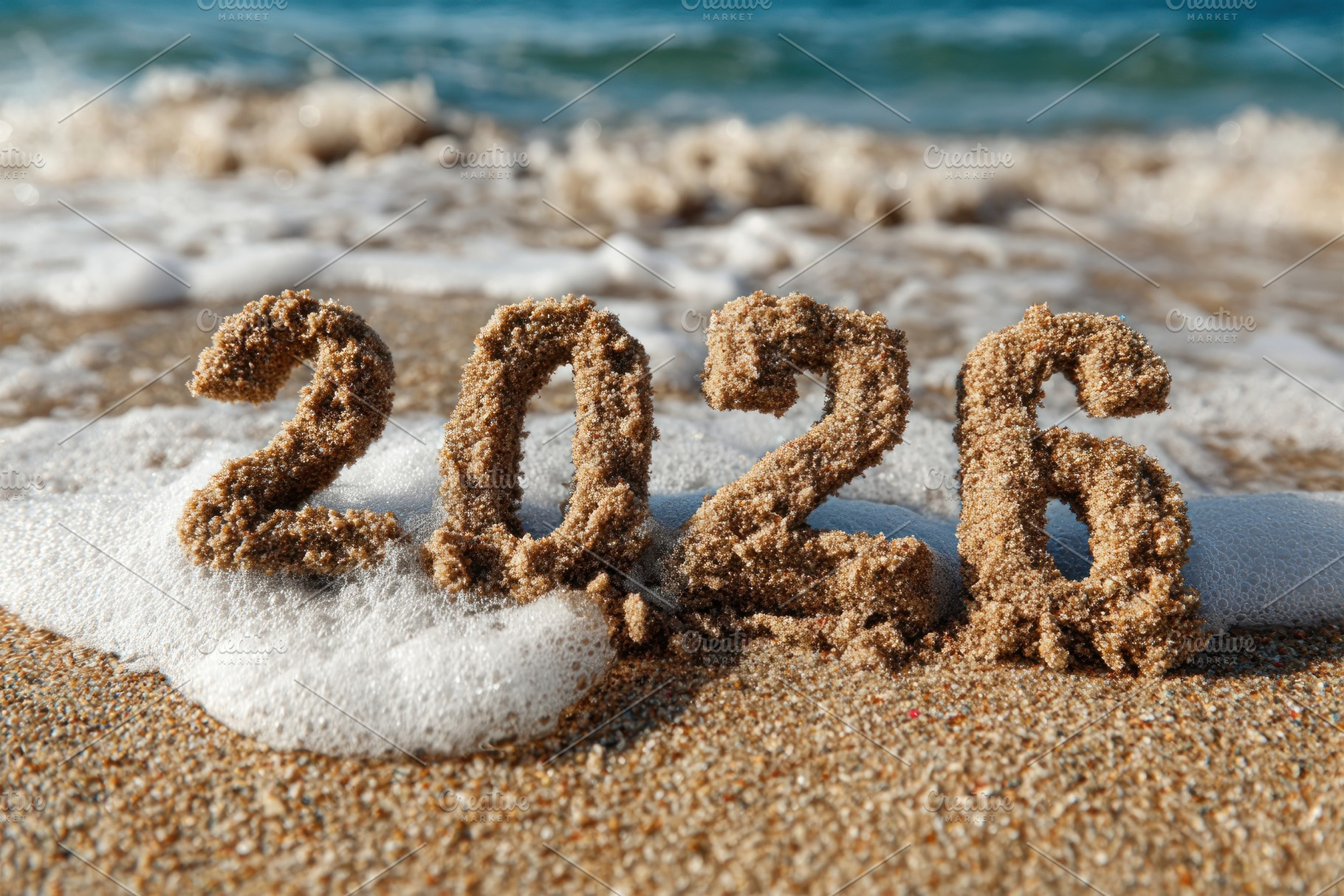 2026 written in sand on tropical beach with ocean waves, coastal, a Holiday Photo by José Manuel Gelpi