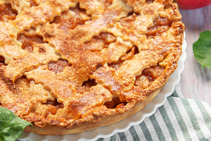 Freshly baked apple pie with red apples and leaves on rustic woo, a Food & Drink Photo by Olena Rudo