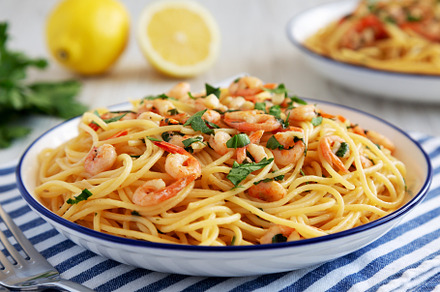 Homemade Garlic Shrimp Scampi with Parsley on a Plate, side view, a Food & Drink Photo by LiudmylaChuhunova