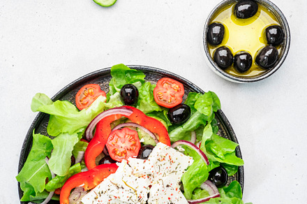 Vegetable greek salad with feta cheese, olives, tomatoes, paprik, a Food & Drink Photo by 5PH