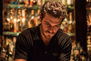 Bartender crafting cocktails behind, a Photo by Pixeness Studio