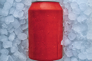 Red can of soda buried in pile of ice cubes, a Food & Drink Photo by Davizro's Market
