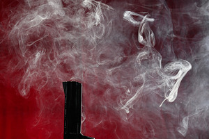 The barrel of a pistol from which thick, white smoke rises, form, a Background Photo by ndanko