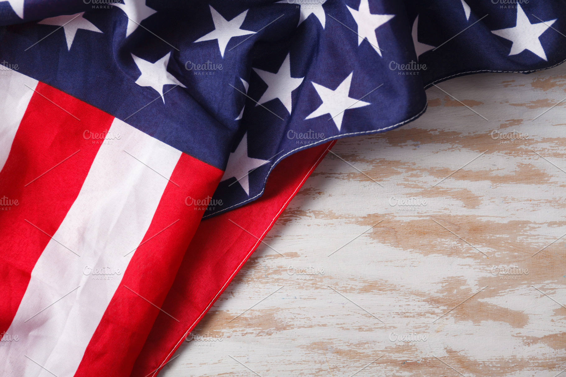 American flag close up on wood desk, a Background Photo by OleksandrRybitskyi