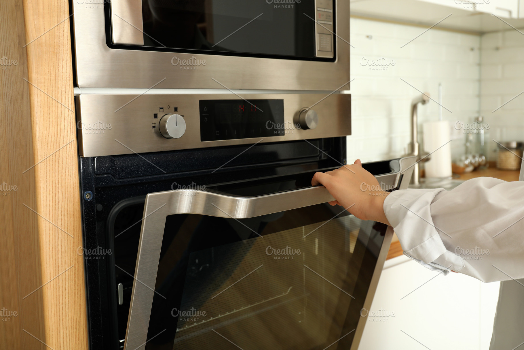 Young woman hand open modern oven in kitchen, an Architecture Photo by AtlasStudio PRO