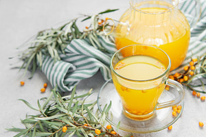 Sea buckthorn berry tea in glass cup and teapot, a Food & Drink Photo by Olena Rudo