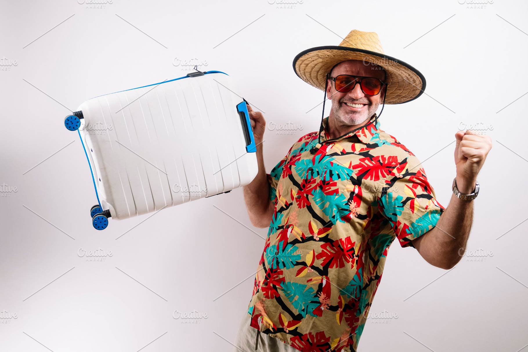 Happy traveler lifting suitcase excitedly, a Holiday Photo by karrastock