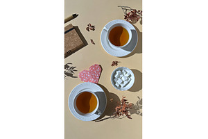 Two cups of tea with sugar cubes, a Photo by tilialucida