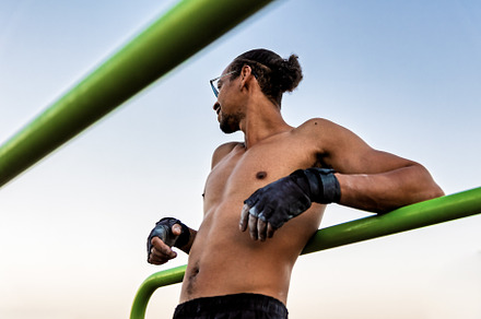 Athlete leaning against a calistheni
