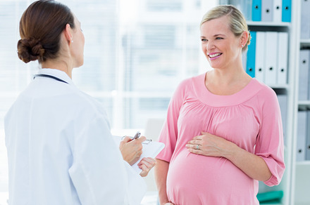 Pregnant woman discussing with female doctor, a Photo by wavebreak