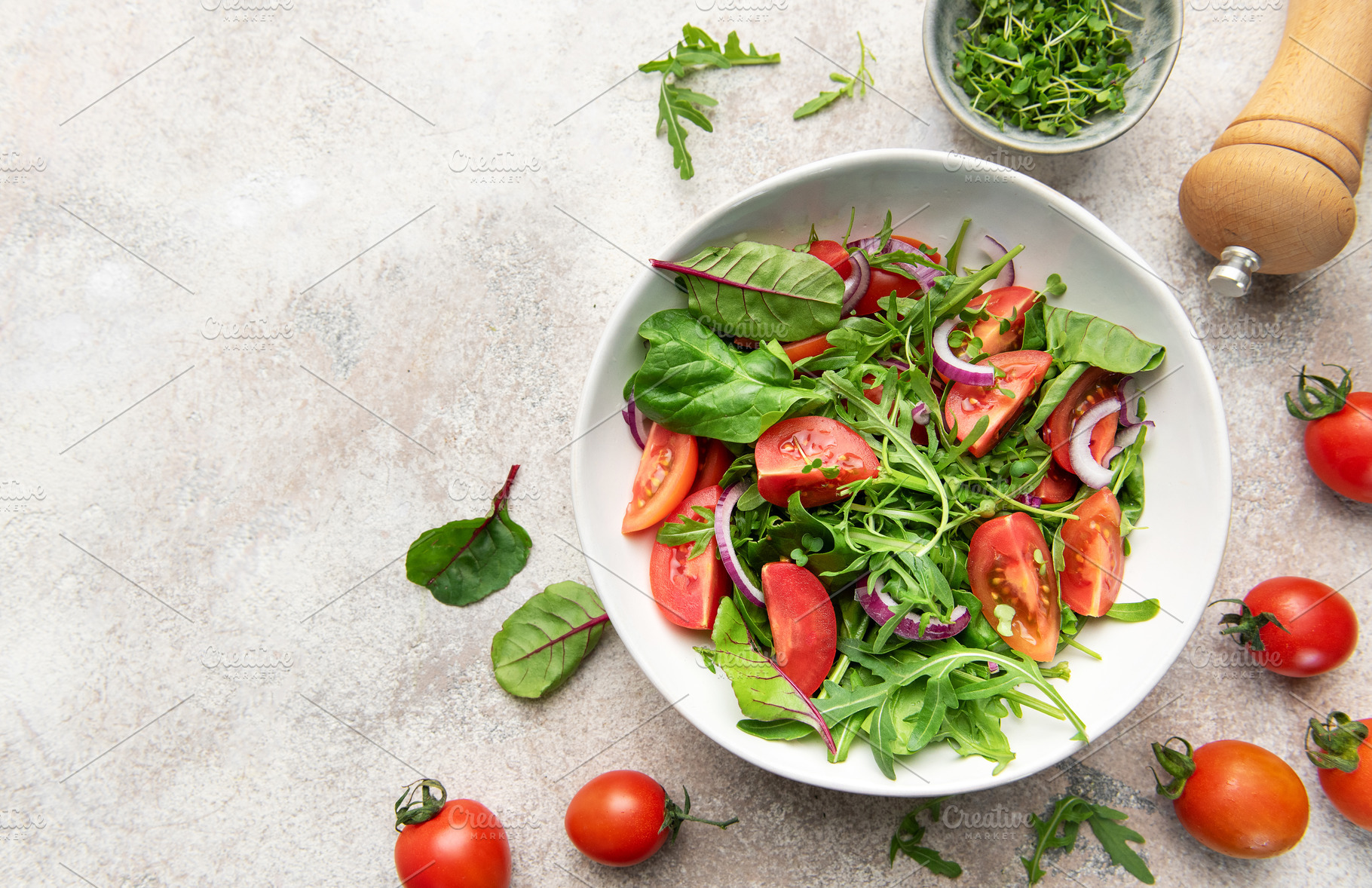 Fresh garden salad with tomatoes, greens, and onions, a Food & Drink Photo by Olena Rudo