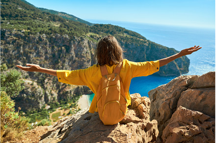 Adventure tourist woman on cliff, a Person Photo by vitaliymateha photography