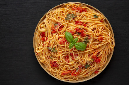 Homemade Spaghetti With Fresh Tomato Sauce on a Plate, top view., a Food & Drink Photo by LiudmylaChuhunova