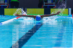 Swimmer child swims butterfly swimming style in a race swimming, a Sports & Recreation Photo by Casanowe-studio