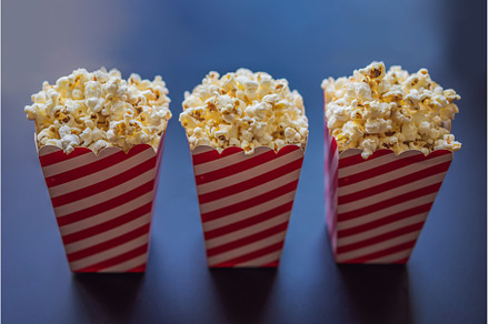 Popcorn in red and white container, a Food & Drink Photo by Elizaveta Galitskaya