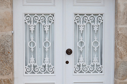 White door in a stone house, an Architecture Photo by José Manuel Gelpi