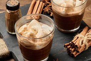 Two glasses of hot chocolate with fluffy marshmallows on a slate, a Food & Drink Photo by ndanko