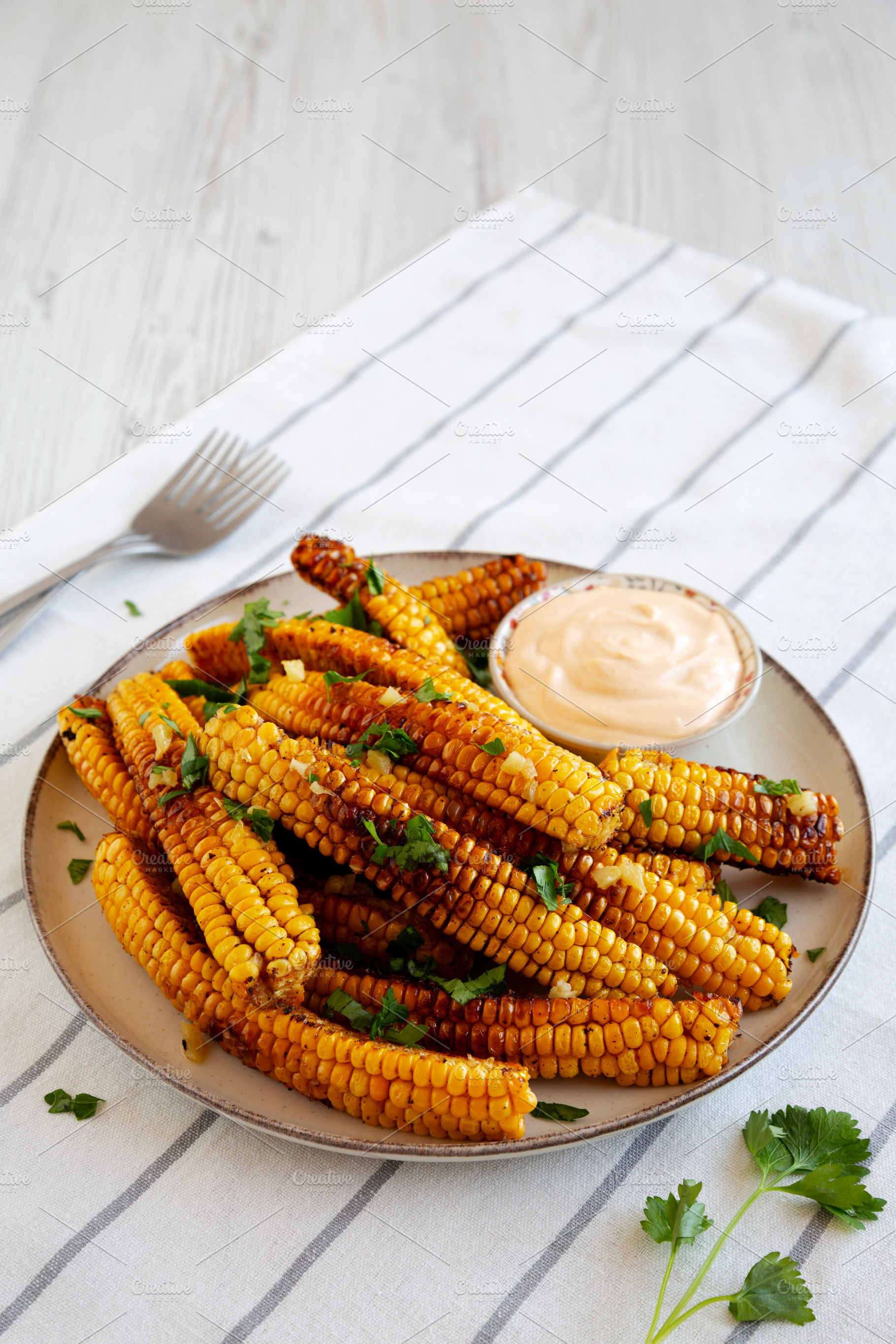 Homemade Spicy Corn Ribs with Mayo on a Plate, side view., a Food & Drink Photo by LiudmylaChuhunova