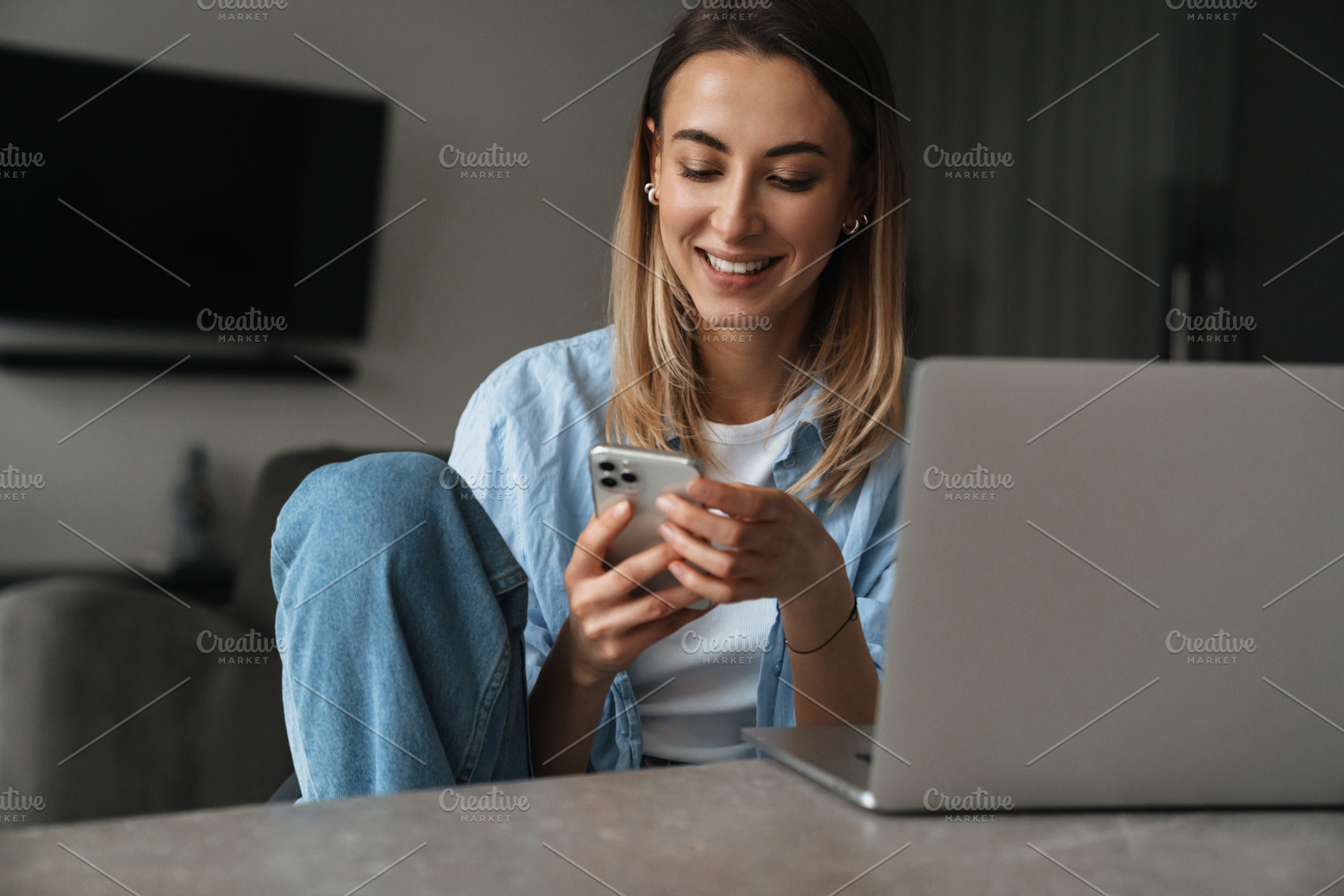 Happy young woman using mobile phone, a Person Photo by Dean Drobot