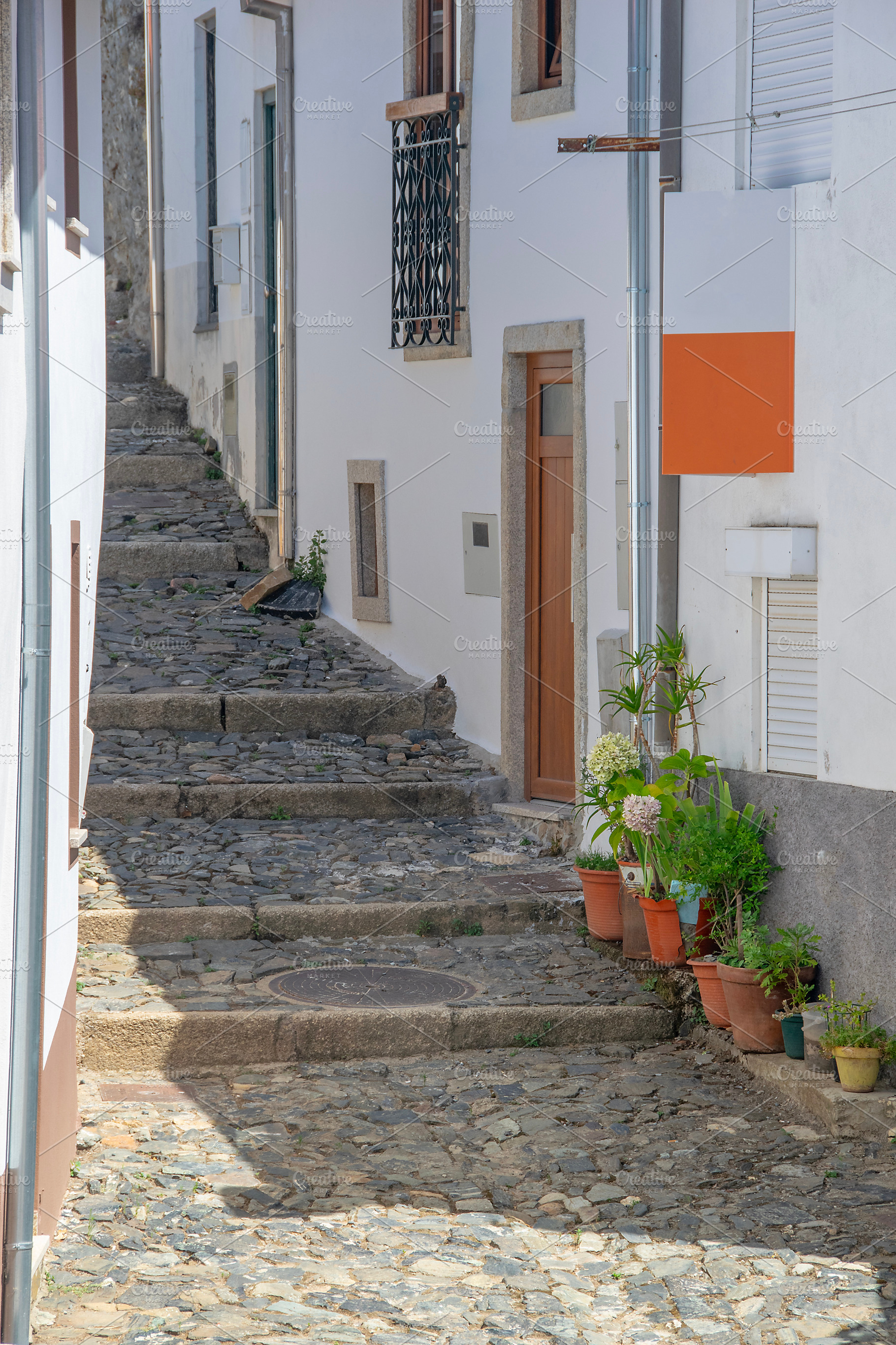 Narrow street of historic center of braganca city, portugal, an Architecture Photo by DanFLCreativo