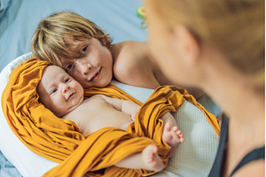 Older brother hugging his newborn, a Person Photo by Elizaveta Galitskaya