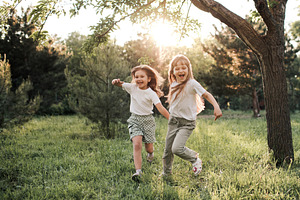Cheerful kid girls in park