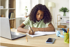 School girl sitting at her desk at