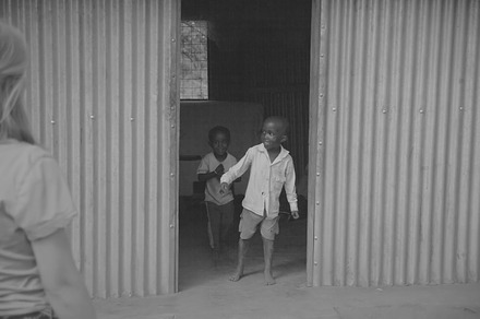 Boy Coming out of House