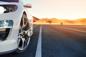 Front of the sports car featuring speed, travel, and traffic