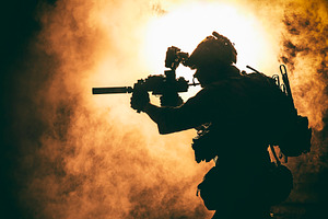 Soldier silhouette on background of featuring silhouette, fire, and flame