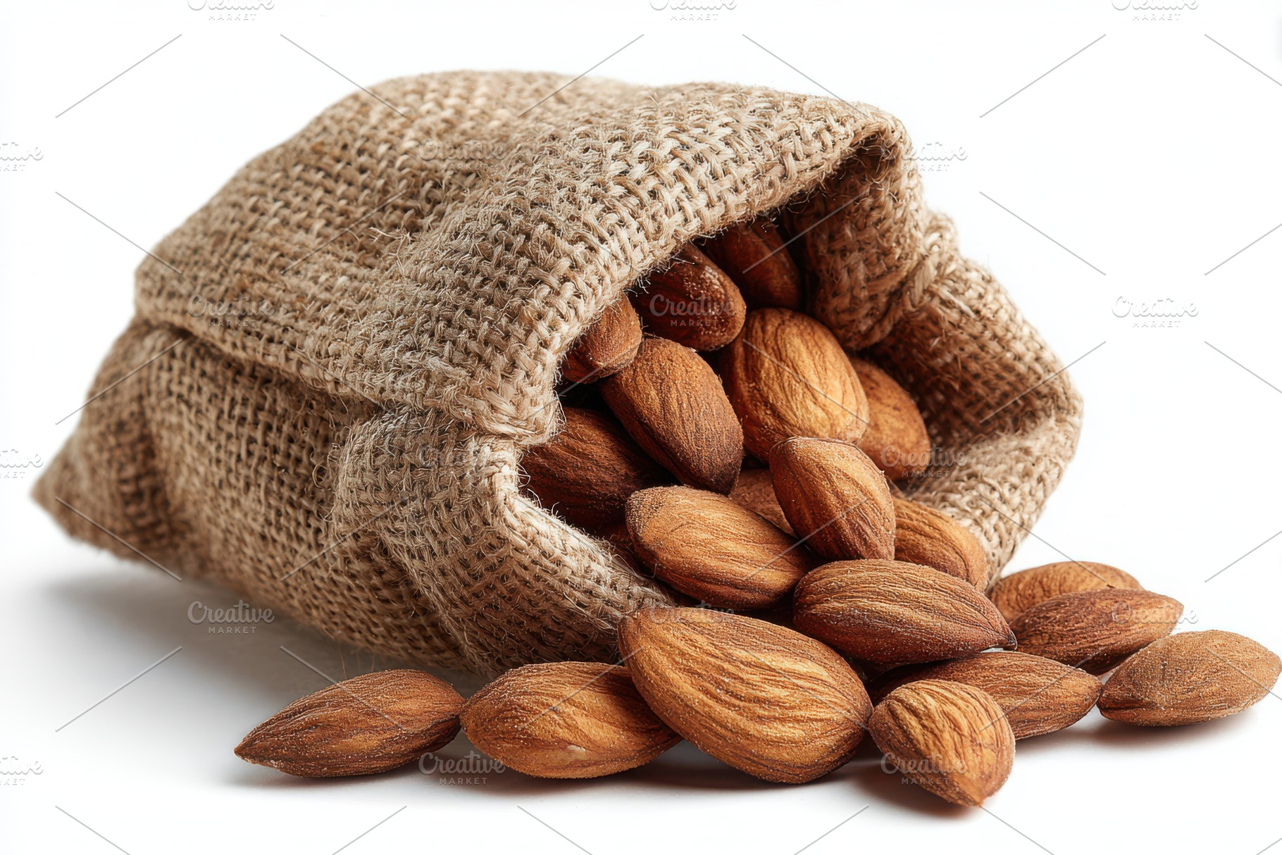 Almonds spilling from burlap sack he, a Photo by Pixeness Studio