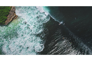 Surfers riding waves at Dreamland, a Nature Photo by Goinyk