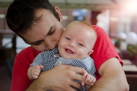 Son with his father in his arms, a Person Photo by NelliKovalchuk