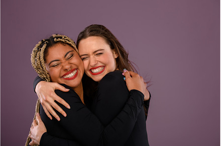 Two happy multiracial friends, a Person Photo by HalfPoint