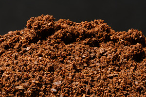 A mountain of freshly ground coarse coffee with pronounced parti, a Food & Drink Photo by ndanko