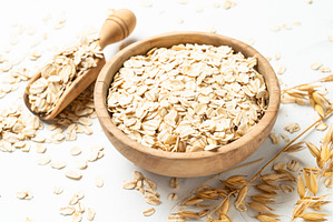 Rolled oats in wooden bowl with, a Food & Drink Photo by Nadia-nb