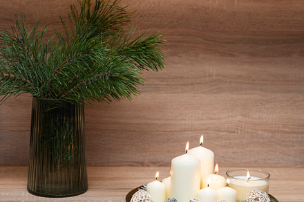 Christmas decor. Pine branches in a vase and candles on a tray, a Holiday Photo by Olena Rudo