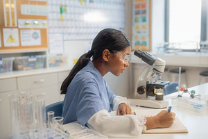 Black teenager student working at laboratory tools and science c, a School & Education Photo by DanFLCreativo