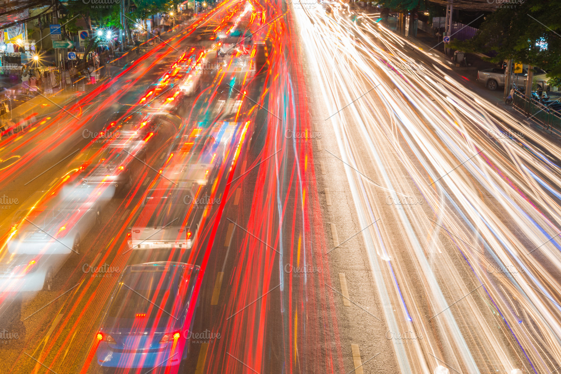 Light streams from ongoing traffic featuring traffic, light, and street, a Transportation Photo by Casanowe-studio