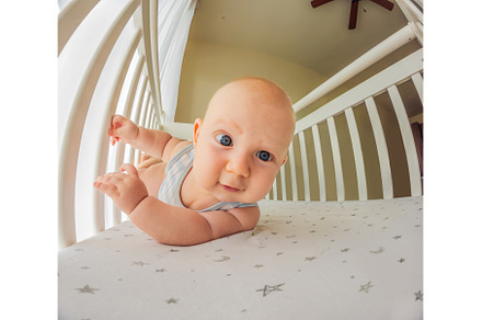 A playful baby in the crib, a Person Photo by Elizaveta Galitskaya