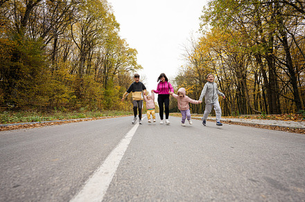 Mother with four kids running on road at autumn fall forest., a Person Photo by AS photostudio